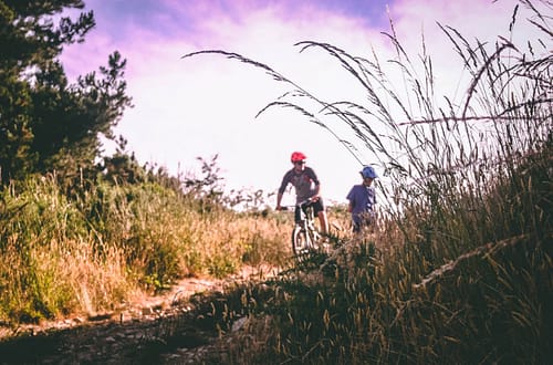 two bikers biking outdoors